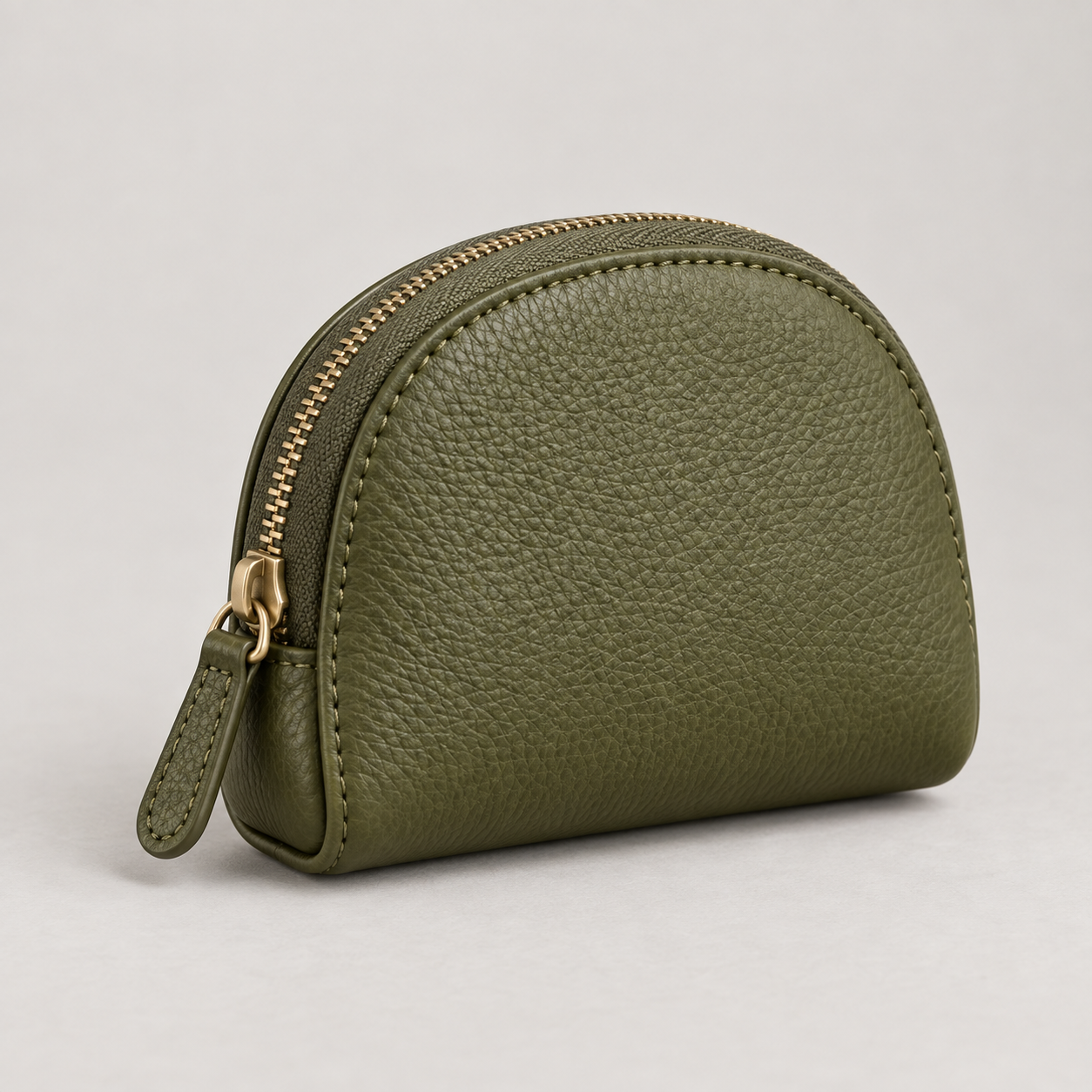 Olive Coin Purse: Rounded small zip coin-purse silhouette with a gusseted side profile. Illustrative design reference.